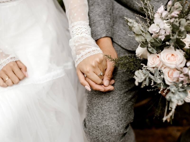couple holding hands on their wedding day