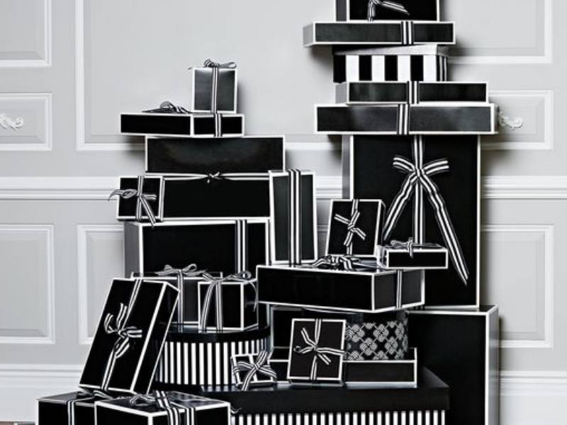 pile of black & white gift hamper boxes with ribbons